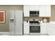 Modern kitchen featuring stainless steel appliances, white cabinets, ample counter space, and stylish design at 4748 E Amethyst Ln, San Tan Valley, AZ 85143