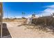 A large gravel backyard, enclosed by a block wall, under a clear blue sky at 4832 W Golden Ln, Glendale, AZ 85302