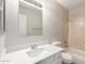 Bathroom featuring a bright vanity, a well-lit mirror, and a tub/shower combo at 4832 W Golden Ln, Glendale, AZ 85302
