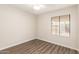 Bedroom features laminate floors, a window, and neutral paint at 4832 W Golden Ln, Glendale, AZ 85302