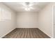This room is equipped with laminate floors, a window, and a ceiling fan at 4832 W Golden Ln, Glendale, AZ 85302