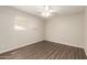 Cozy bedroom with light walls, wood-look floors, and a window at 4832 W Golden Ln, Glendale, AZ 85302