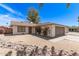 A charming single-story home with desert landscaping and beautiful flowering bushes at 4832 W Golden Ln, Glendale, AZ 85302