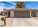 A single-story home with a two-car garage sits beneath a blue sky at 4832 W Golden Ln, Glendale, AZ 85302