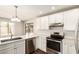 Stylish kitchen with stainless steel appliances, white cabinetry, and quartz countertops at 4832 W Golden Ln, Glendale, AZ 85302