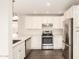 Bright kitchen boasts stainless steel appliances, white cabinets, and ample counter space for cooking at 4832 W Golden Ln, Glendale, AZ 85302