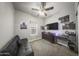 A cozy bedroom offers a comfortable couch, TV, dresser, and a ceiling fan for added comfort at 500 N 67Th Ave # 52, Phoenix, AZ 85043