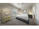 This bedroom features neutral walls and carpet along with a decorative mirror and ornate lamp at 500 N 67Th Ave # 52, Phoenix, AZ 85043