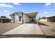 Exterior view of home with a covered parking spot, rock landscaping, and freshly painted facade at 500 N 67Th Ave # 52, Phoenix, AZ 85043