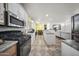 Modern kitchen with white cabinetry, stainless steel appliances, and an eat-in bar at 500 N 67Th Ave # 52, Phoenix, AZ 85043