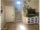 Home foyer featuring tile flooring, staircase, and a decorative plant near the television at 546 E San Carlos Way, Chandler, AZ 85249