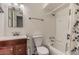 Well-lit bathroom offering a vanity with storage, a toilet, and a shower-tub combination for functionality at 5801 W Cortez St, Glendale, AZ 85304