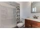 Bathroom featuring a cherry vanity, toilet, shower-tub combo, and a mirror for daily routines at 5801 W Cortez St, Glendale, AZ 85304