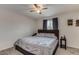 Comfortable bedroom with a ceiling fan, neutral walls, and a patterned duvet creating a calm and restful space at 5801 W Cortez St, Glendale, AZ 85304