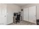 Bedroom featuring an office space with an office chair and sliding closet doors for storage solutions at 5801 W Cortez St, Glendale, AZ 85304