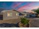 Charming single-story home with desert landscaping and a picturesque sunset sky at 5801 W Cortez St, Glendale, AZ 85304