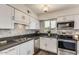 Modern kitchen features stainless steel appliances, gray countertops, mosaic tile backsplash, and ample cabinet space at 5801 W Cortez St, Glendale, AZ 85304