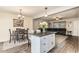 Open floorplan features a dining area, kitchen island with seating, and comfortable living space at 5801 W Cortez St, Glendale, AZ 85304