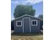 Cozy backyard shed with gray siding and bright white trim around the windows and door at 5801 W Cortez St, Glendale, AZ 85304
