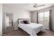 Serene bedroom featuring a comfortable bed, mirrored accent wall, and natural light from the window at 5995 N 78Th St # 2004, Scottsdale, AZ 85250