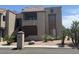 Exterior shot of a tan building with a tile roof, stone accents and desert landscaping at 5995 N 78Th St # 2004, Scottsdale, AZ 85250