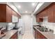 Efficient kitchen features white appliances, wood cabinets, and convenient storage solutions at 5995 N 78Th St # 2004, Scottsdale, AZ 85250