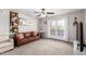 Inviting living room featuring a brown sofa, neutral walls, and access to the outdoors via French doors at 5995 N 78Th St # 2004, Scottsdale, AZ 85250