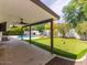 This backyard features a covered patio area, swimming pool, fire pit, and putting green at 6154 E Karen Dr, Scottsdale, AZ 85254