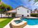 This backyard boasts a swimming pool, spa, covered patio, and putting green, perfect for relaxing at 6154 E Karen Dr, Scottsdale, AZ 85254