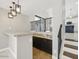 Stylish bar area with granite countertops and dark wood cabinets, open to the kitchen at 6154 E Karen Dr, Scottsdale, AZ 85254