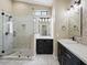 Modern bathroom featuring a walk-in shower and a single sink vanity with black cabinets at 6154 E Karen Dr, Scottsdale, AZ 85254