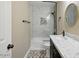 Modern bathroom featuring a tub-shower combination with marble-look tile and stylish vanity with white countertop at 6154 E Karen Dr, Scottsdale, AZ 85254