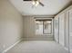 View of carpeted bedroom featuring a ceiling fan, a window, and a closet for storage at 6154 E Karen Dr, Scottsdale, AZ 85254