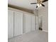 Carpeted bedroom featuring a ceiling fan, multiple closets, and access to additional room at 6154 E Karen Dr, Scottsdale, AZ 85254