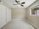A bright bedroom featuring neutral carpet, a ceiling fan, and a closet at 6154 E Karen Dr, Scottsdale, AZ 85254