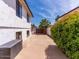 This home features a long driveway leading to the property with lush landscaping and a partial view of the backyard at 6154 E Karen Dr, Scottsdale, AZ 85254