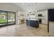 Open-concept kitchen with a large island, granite countertops, stainless steel appliances, and backyard access at 6154 E Karen Dr, Scottsdale, AZ 85254