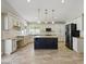 Bright kitchen features white cabinets, an island, and stainless steel appliances at 6154 E Karen Dr, Scottsdale, AZ 85254