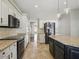 Open-concept kitchen with a large island, granite countertops, stainless steel appliances, and backyard access at 6154 E Karen Dr, Scottsdale, AZ 85254