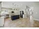 Open-concept kitchen with a large island, granite countertops, stainless steel appliances, and backyard access at 6154 E Karen Dr, Scottsdale, AZ 85254