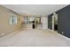 Spacious living room with neutral carpet, recessed lighting, a wet bar, and nearby staircase at 6154 E Karen Dr, Scottsdale, AZ 85254
