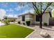 Exterior view of home featuring rocks for landscaping with a lush green lawn at 6204 W Hedgehog Pl, Phoenix, AZ 85083