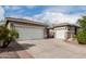 A large driveway and three car garage offer ample parking and storage space at 6204 W Hedgehog Pl, Phoenix, AZ 85083