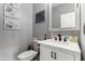 Stylish half bathroom featuring a vanity with elegant sink, modern faucet, and decorative mirror at 6204 W Hedgehog Pl, Phoenix, AZ 85083