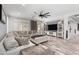 Bright, open-concept living room with a comfortable sectional sofa and plank flooring at 6204 W Hedgehog Pl, Phoenix, AZ 85083