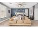 Serene main bedroom showcasing a cozy couch in front of a king bed and decoratively designed wall at 6204 W Hedgehog Pl, Phoenix, AZ 85083