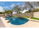 Inviting private pool with rock waterfall, surrounded by lush landscaping and sunny skies at 6204 W Hedgehog Pl, Phoenix, AZ 85083