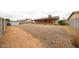 Expansive backyard with desert landscaping, covered patio, and storage shed at 6313 W Paradise Ln, Glendale, AZ 85306