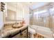 Bathroom with granite countertops, vessel sink, and a modern shower with glass door at 6313 W Paradise Ln, Glendale, AZ 85306