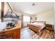 Comfortable bedroom featuring wood laminate flooring and a bright window at 6313 W Paradise Ln, Glendale, AZ 85306